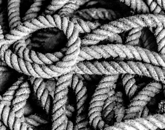 A closeup shot of a grey rope in a twisted position