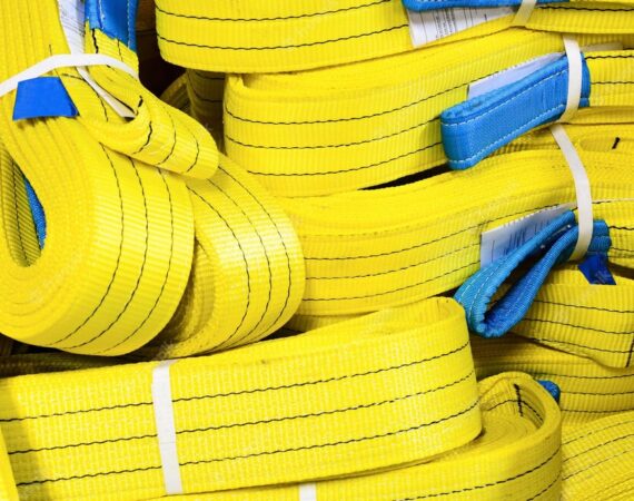 yellow-nylon-soft-lifting-slings-stacked-piles_143715-2186